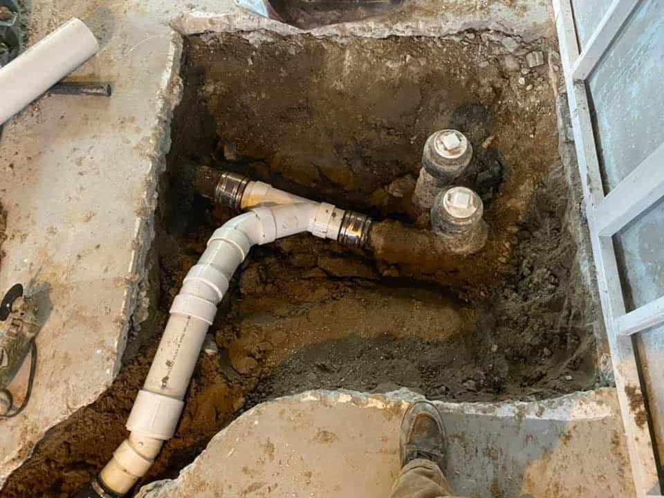 Thompson Trenchless and Hydro Jetting shows pipe repair under a floor, explaining why damaged pipes may need fixing.