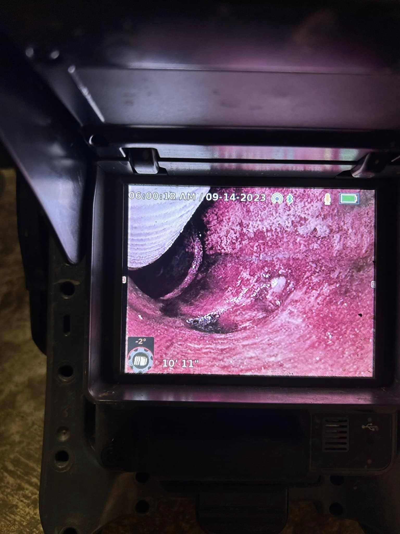 Thompson Trenchless and Hydro Jetting monitor shows pipe with buildup inside during an inspection, highlighting blockage.