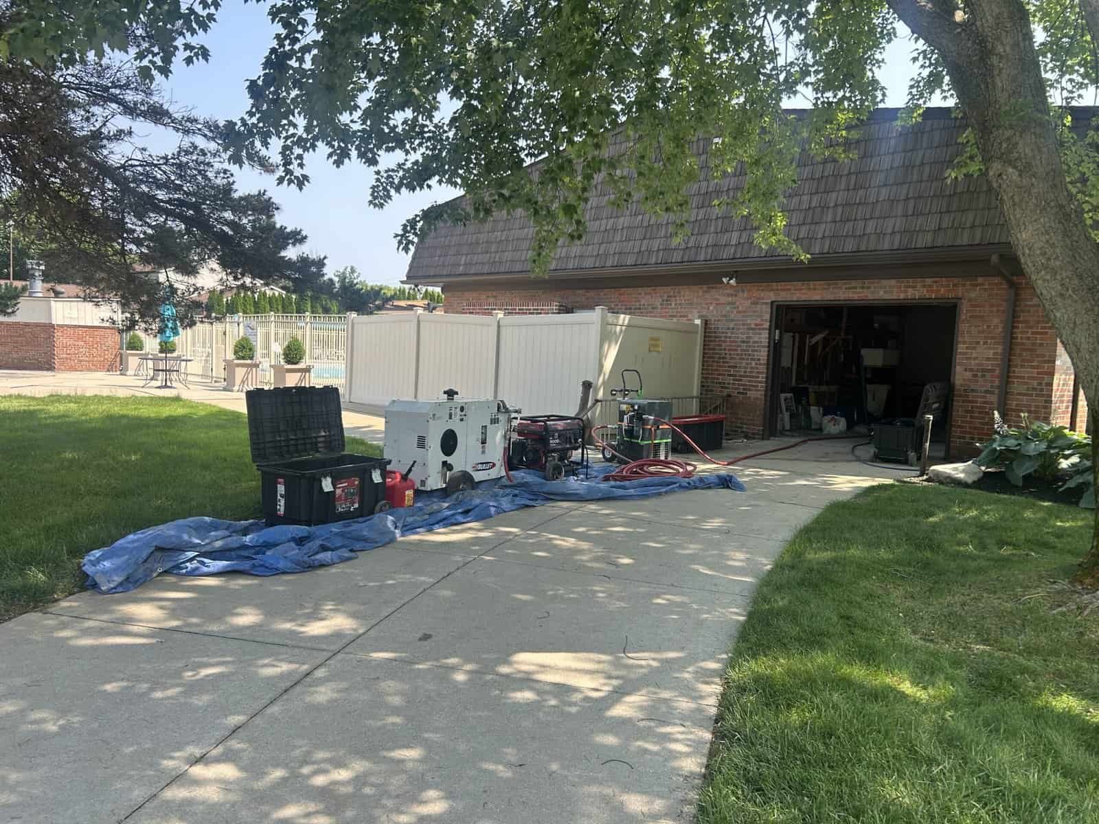 Thompson Trenchless and Hydro Jetting has pipe inspection tools ready for drain jobs outside their open garage.