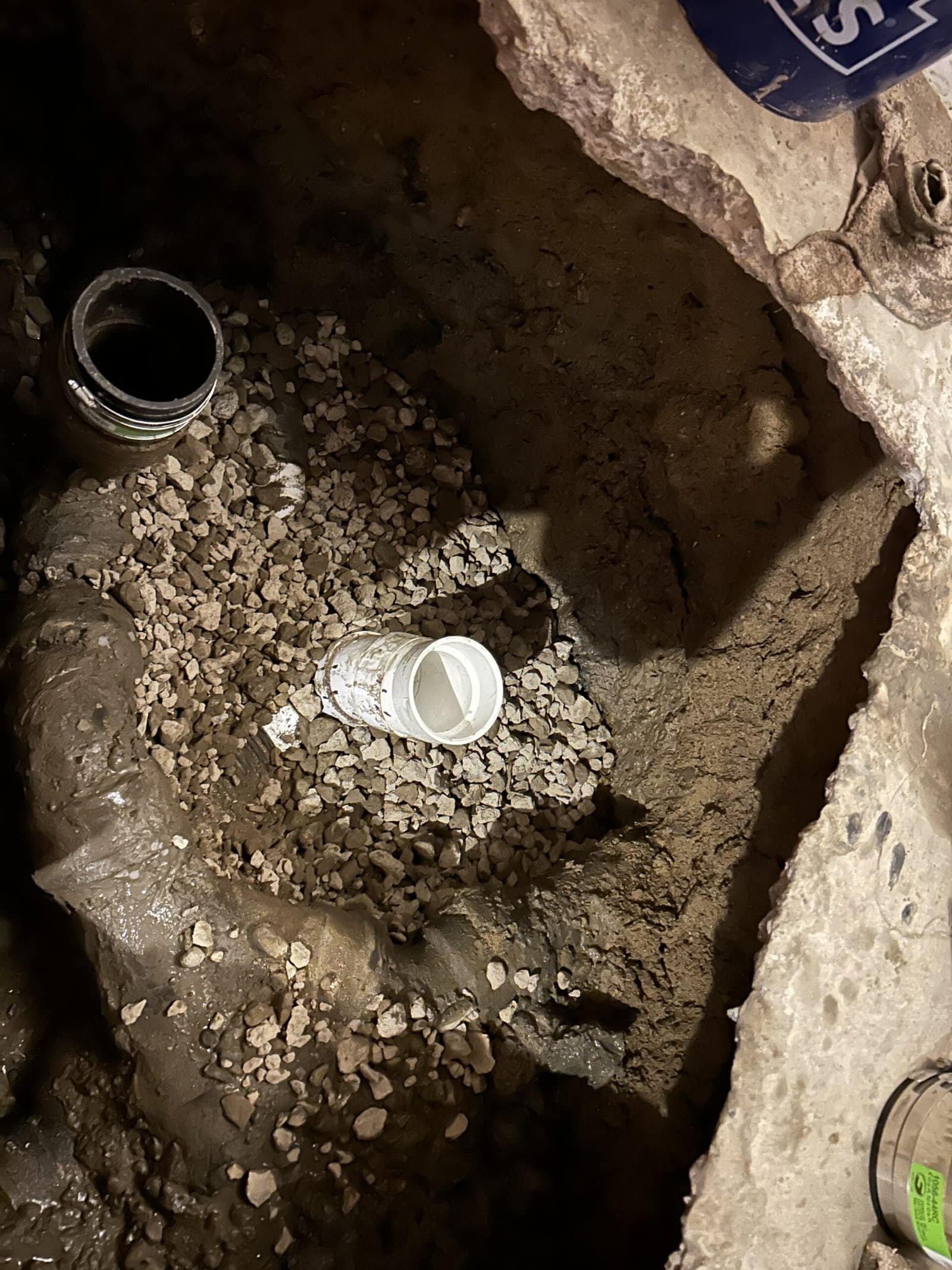 Thompson Trenchless and Hydro Jetting fixing an indoor sewer pipe as part of a plumbing repair project.