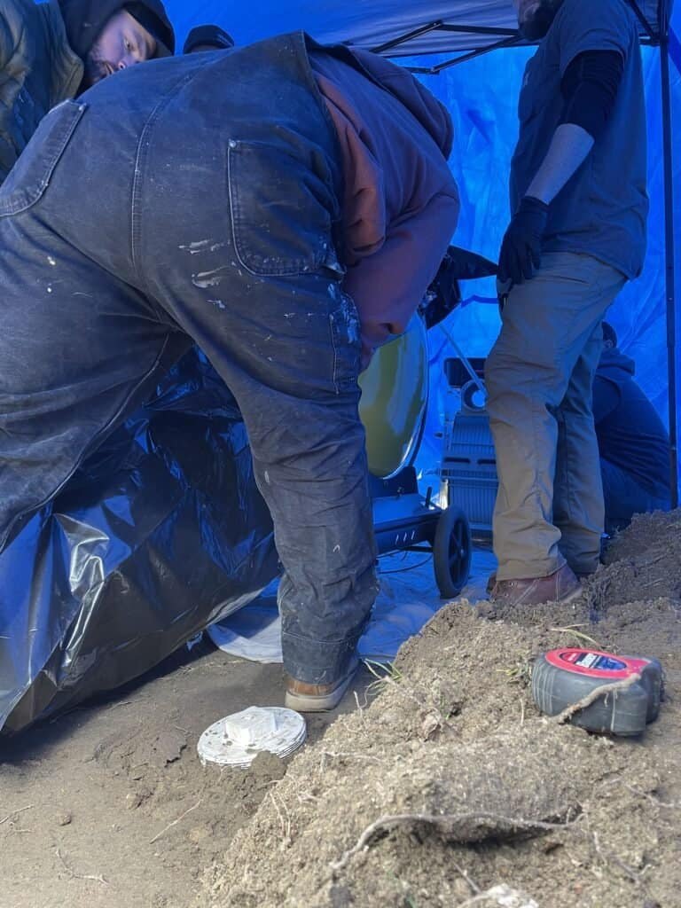 Thompson Trenchless and Hydro Jetting crew works together on a sewer repair, showing teamwork and attention to the job.