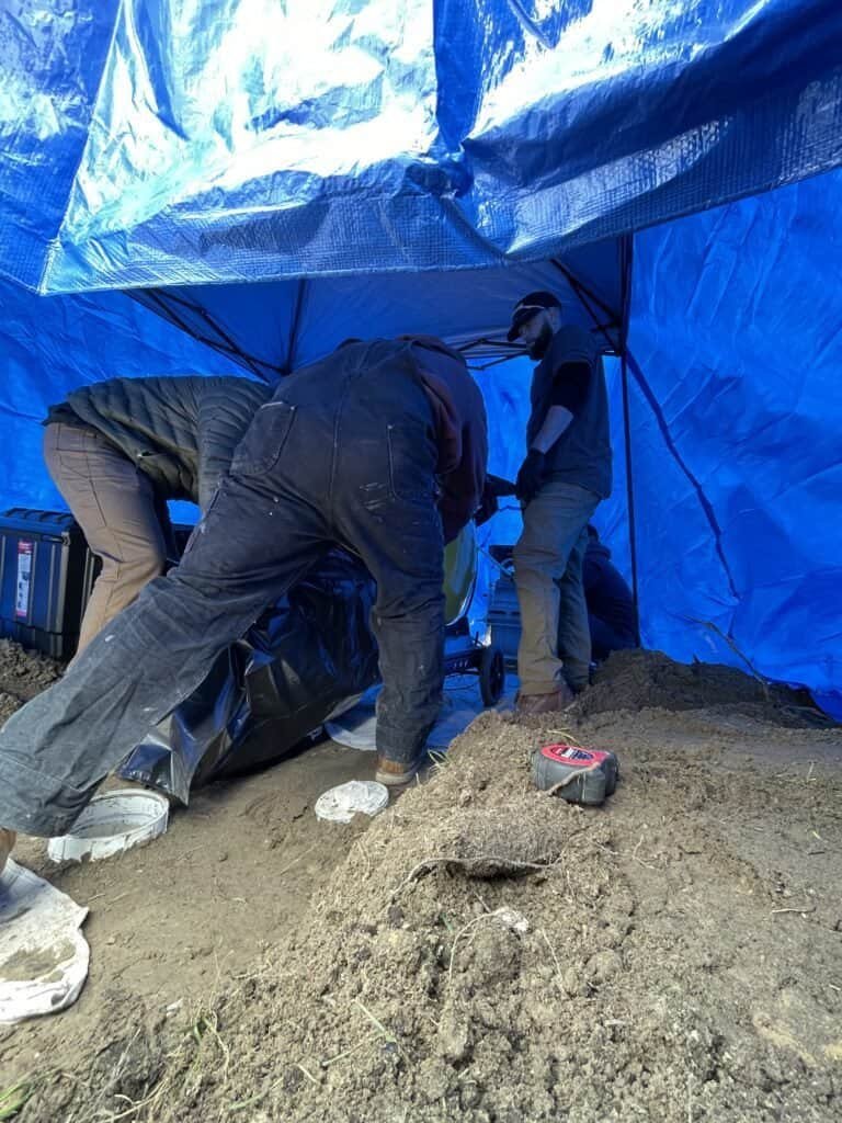 Thompson Trenchless and Hydro Jetting team repairs pipes underground, working carefully to fix sewer or water line issues.