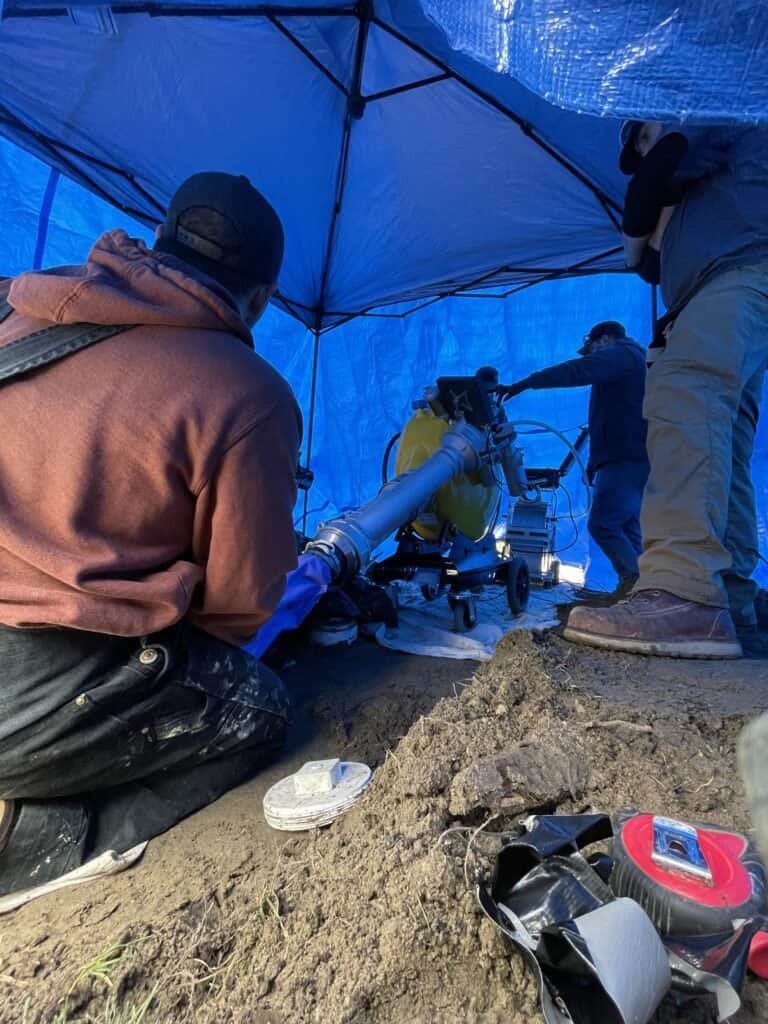 Thompson Trenchless and Hydro Jetting team repairs sewer lines using special equipment for cleaning and inspection.