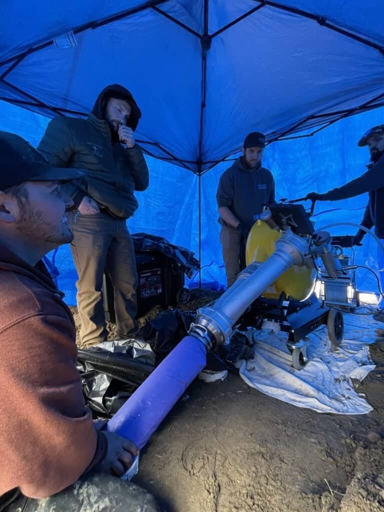 Thompson Trenchless and Hydro Jetting team checking pipes and equipment, working together to solve pipe problems.