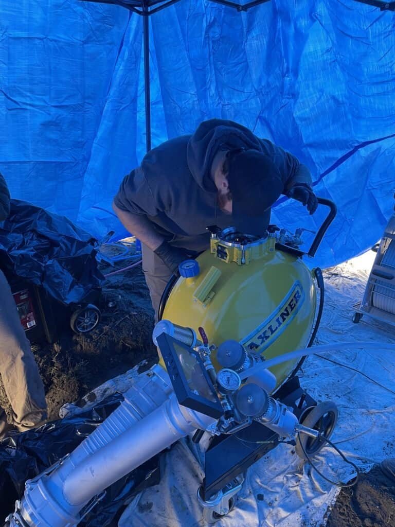 Thompson Trenchless and Hydro Jetting staff uses advanced tools outdoors to provide reliable pipe repair services.