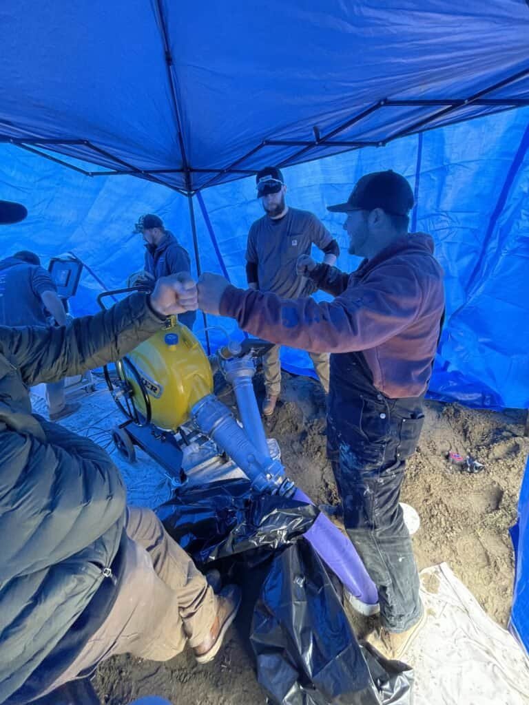 Thompson Trenchless and Hydro Jetting team working together on a repair project, showing teamwork and service expertise.