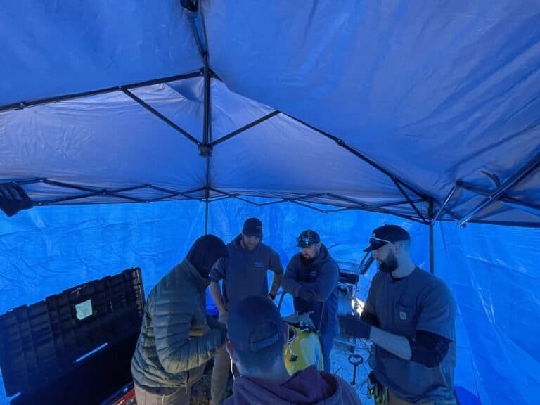 Thompson Trenchless and Hydro Jetting crew works as a team to repair pipes, showing teamwork and problem-solving.