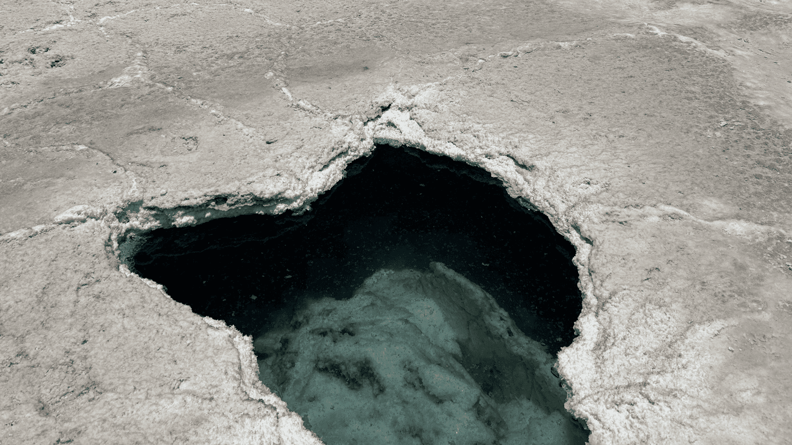 Thompson Trenchless and Hydro Jetting checks tough buildup like what’s seen in this pit with clear water and white deposits.