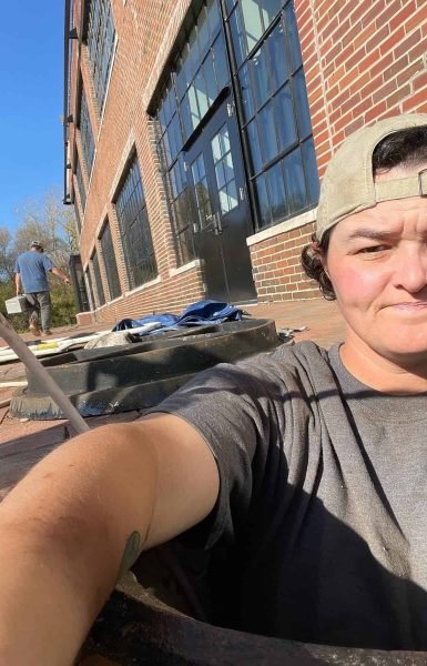 Thompson Trenchless and Hydro Jetting workers take a break during a pipe repair job outside on a sunny day.
