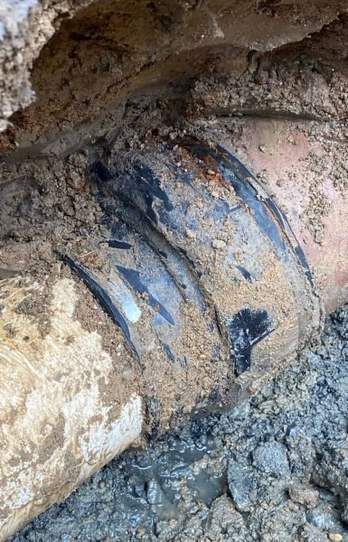 Thompson Trenchless and Hydro Jetting shows how pipe leaks are fixed to stop water in wet, muddy ground.