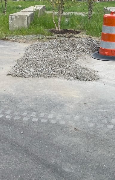 Work by Thompson Trenchless and Hydro Jetting is shown after repairs, with gravel and safety barrel nearby.