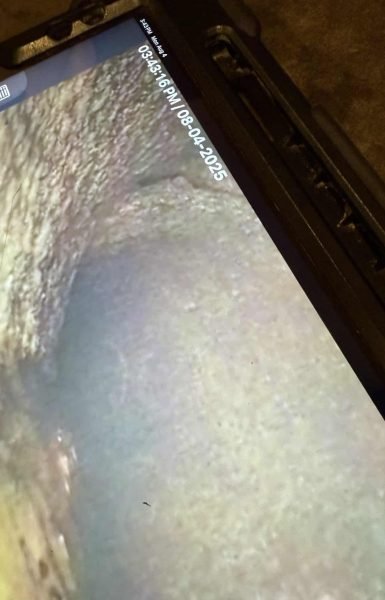 Thompson Trenchless and Hydro Jetting checks sewer pipes with a camera to find problems, showing results on a screen.