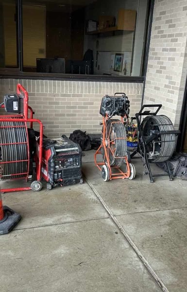 Thompson Trenchless and Hydro Jetting equipment onsite for pipe inspection or sewer line repairs at a building.