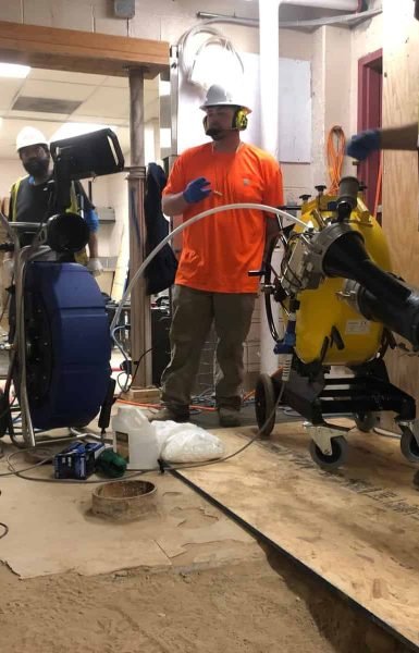 Thompson Trenchless and Hydro Jetting crew repairs building sewer lines using safe, modern equipment during renovations.