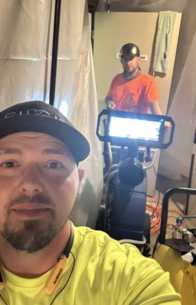 Workers from Thompson Trenchless and Hydro Jetting repair sewer lines, showing teamwork and plumbing expertise on the job.