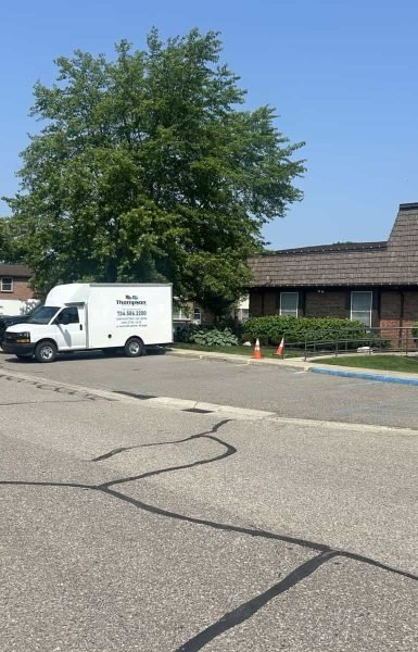 Thompson Trenchless and Hydro Jetting vans are ready to help customers at their office on a bright, pleasant day.