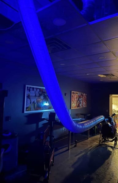 Thompson Trenchless and Hydro Jetting shows a workspace with pipe inspection tools and sports pictures on the walls.