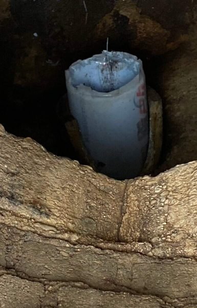 A candle in a stone holder, resembling Thompson Trenchless and Hydro Jetting’s tools, shows durability and dependability.