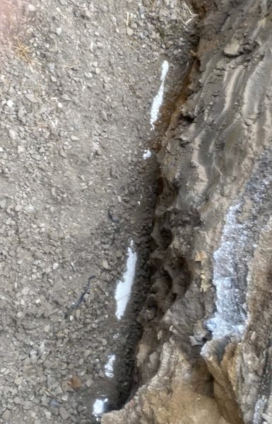 Thompson Trenchless and Hydro Jetting shows the ground after recent pipe repair work, with clear signs of heavy equipment use.