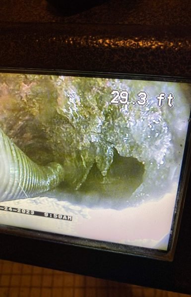 Thompson Trenchless detects tough buildup and a big crack in a pipe, showing the need for professional pipe cleaning.