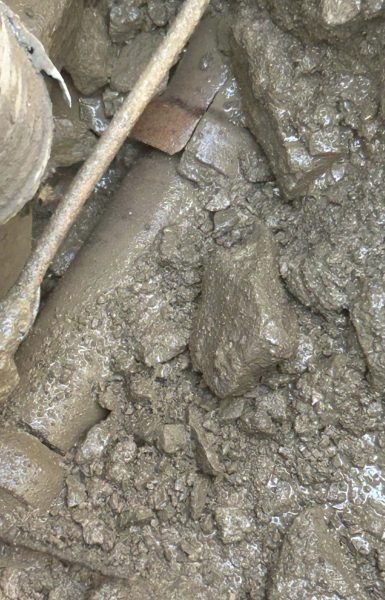 Thompson Trenchless and Hydro Jetting works in tough, muddy spots, showing why fixing sewer pipes can be challenging.