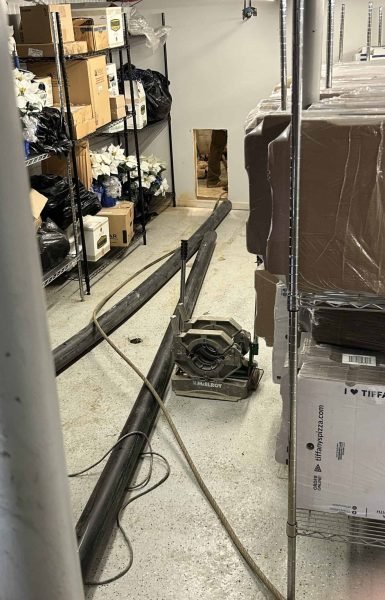 Thompson Trenchless and Hydro Jetting is working in a damp storage room to fix sewer lines and improve safety.