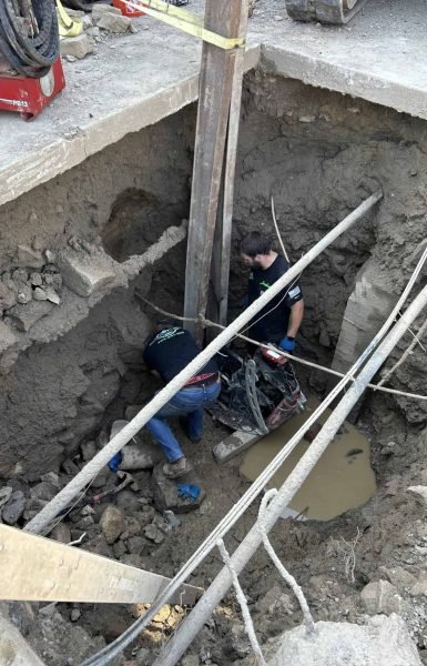 Thompson Trenchless and Hydro Jetting workers repair sewer lines in wet, tricky ground, showing their skill with tough jobs.