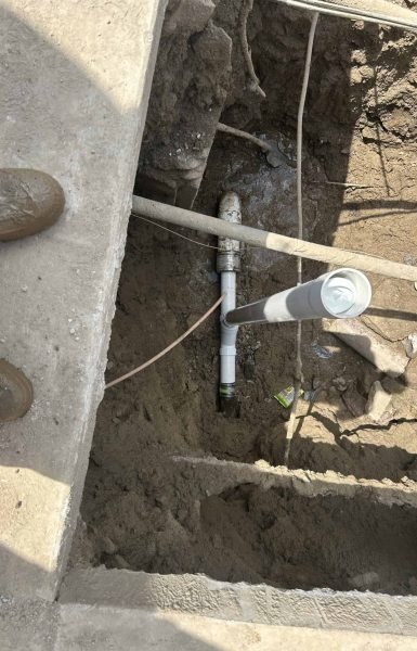 Thompson Trenchless and Hydro Jetting team inspects a plumbing pipe shown during a safe, careful repair process.